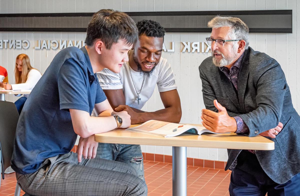 Professor talking with two students